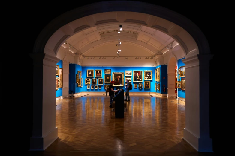 the inside of a museum with blue and orange walls