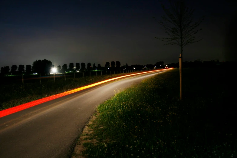 the image of a street at night with long exposure