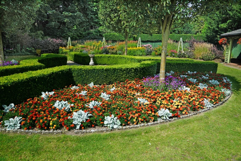 a very big beautiful flower garden surrounded by a circle of plants