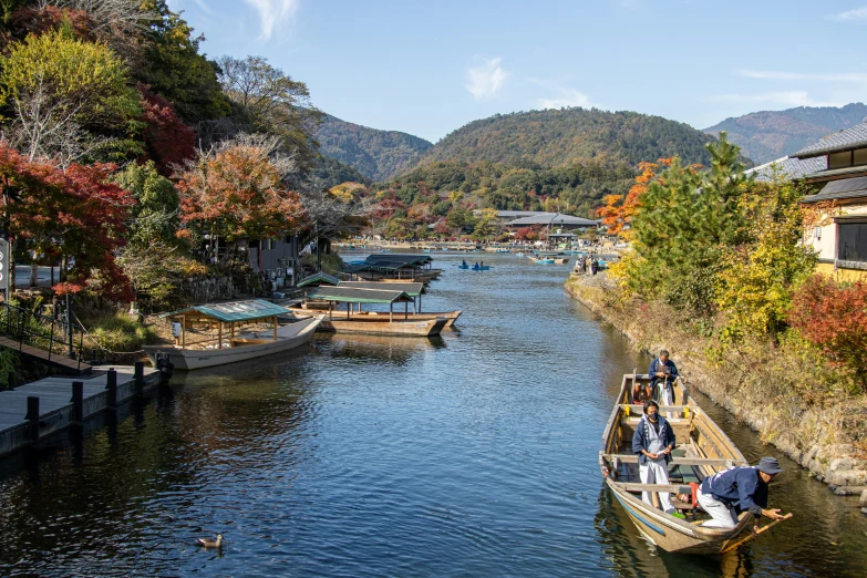 small boats docked in the water near buildings and trees