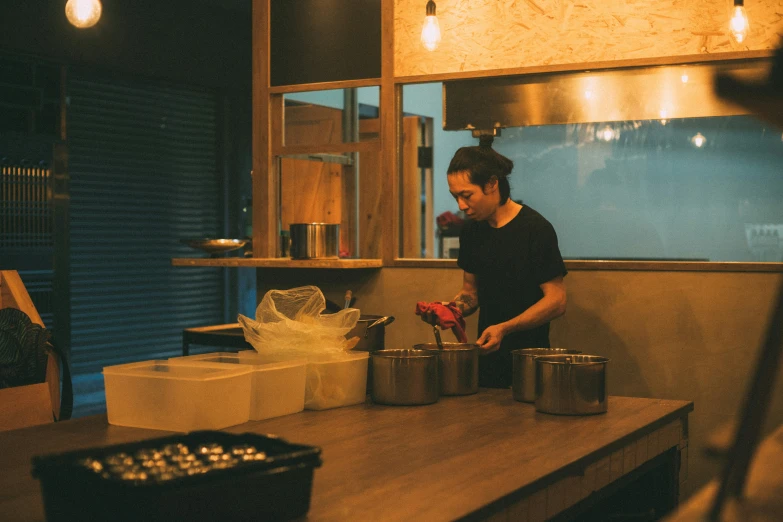 a man standing next to an old stove in a kitchen