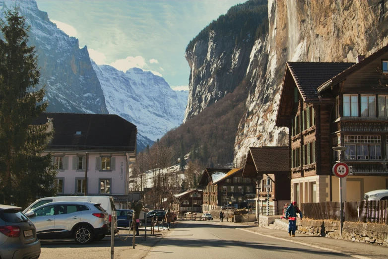 a man riding a bike on a street with mountains in the background