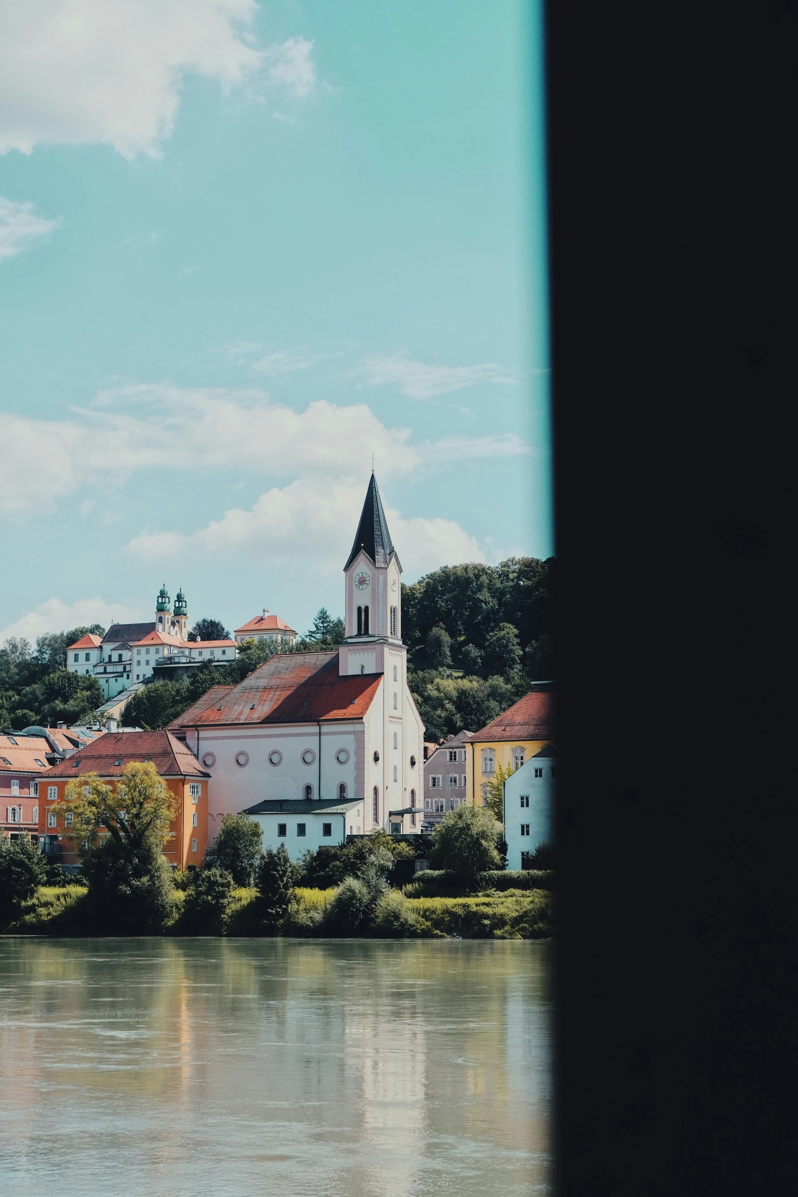 a church sits in the background of the water