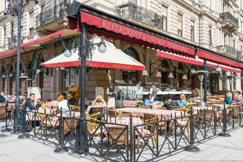 a street with some tables and umbrellas