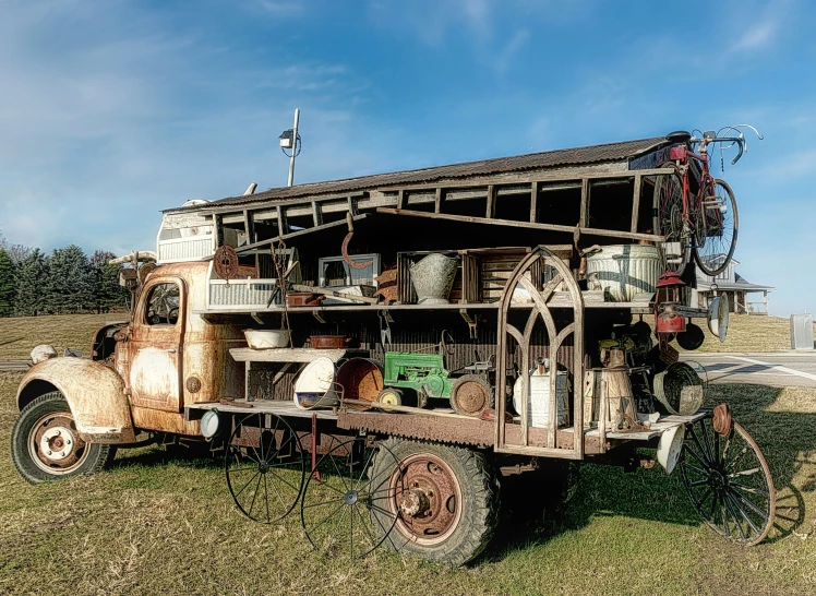 an old truck sitting in a grass field