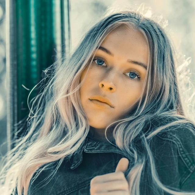 a beautiful blonde wearing black posing for the camera