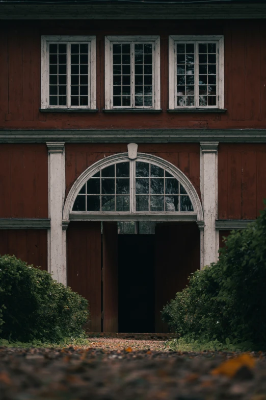 an image of a red house with white windows