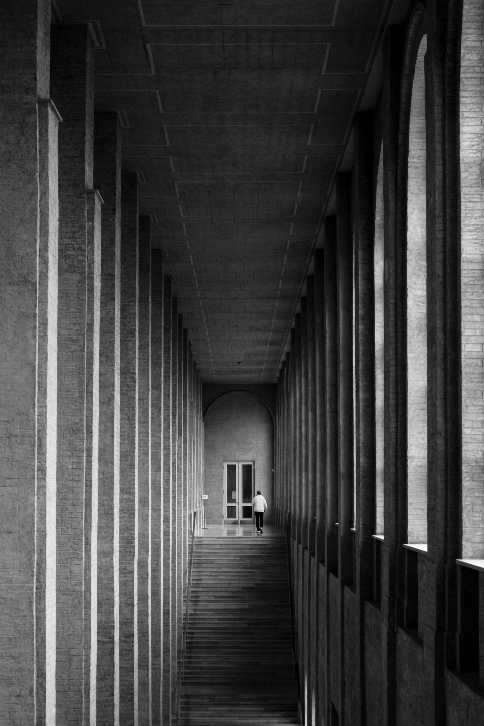 the back of a dark building with large pillars