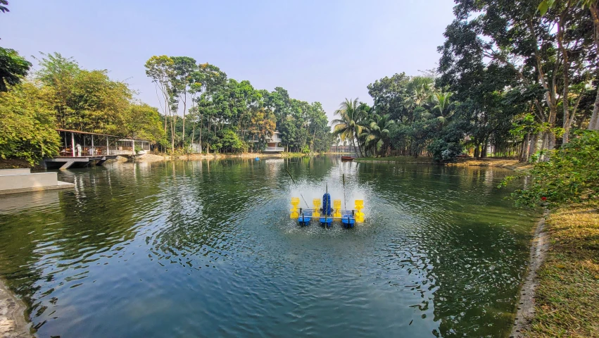 some people paddle boats on a river near many trees