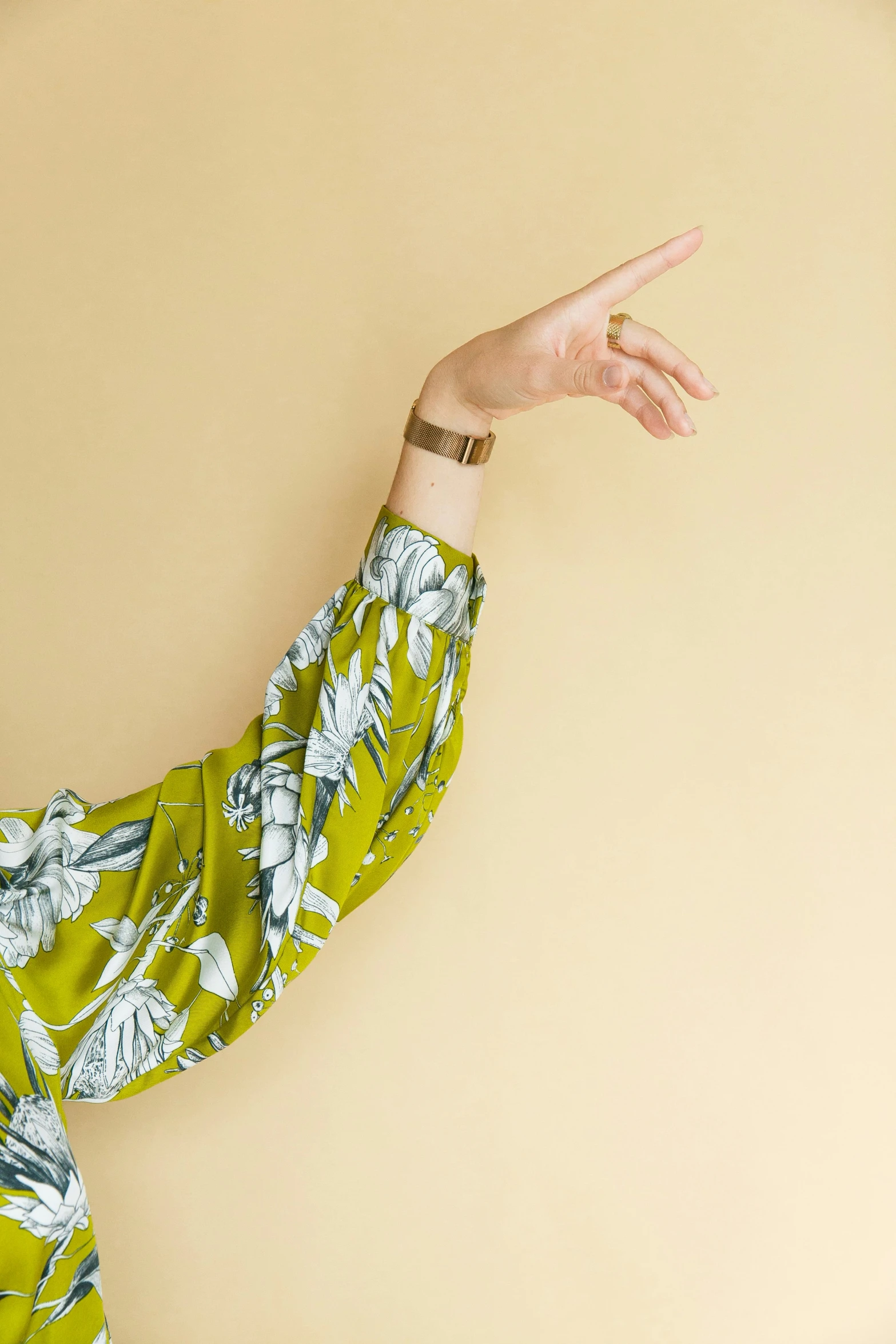 a woman standing on top of a wooden floor with her arms out in the air