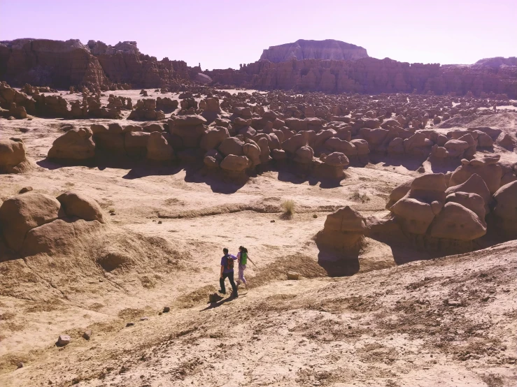 two people walking in an arid desert land