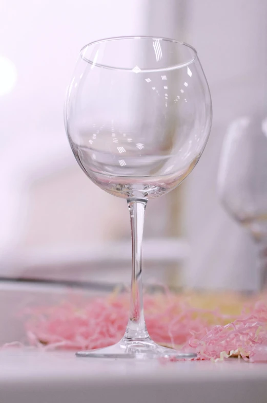 a clear wine glass on a table