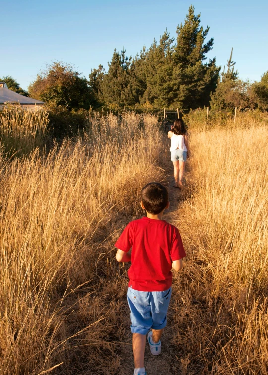 a small child is walking near another 