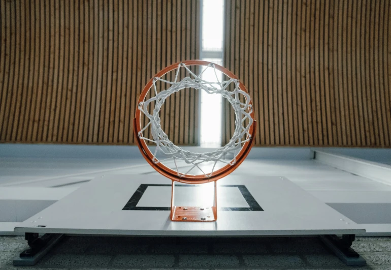 a hoop is displayed in the center of an indoor court