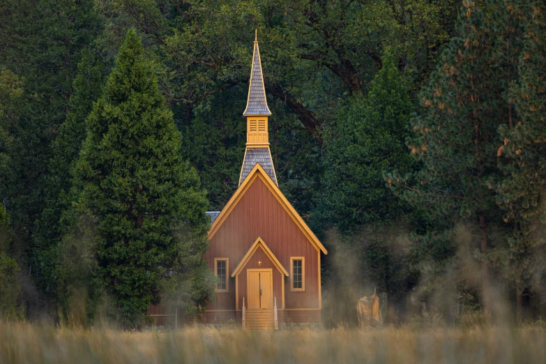 the small church is situated between trees and grass