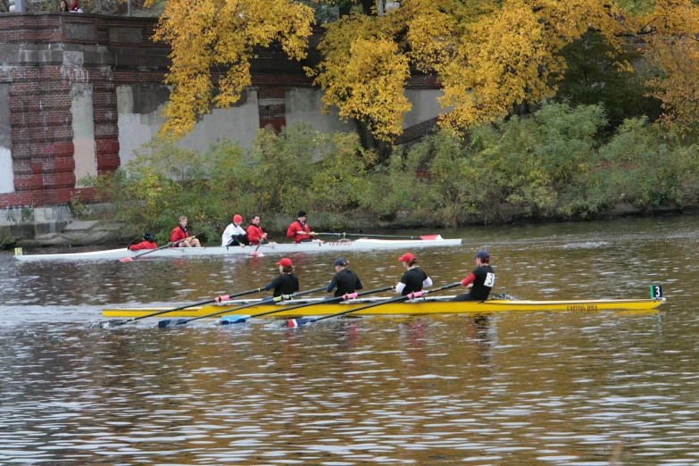 four people on boats are riding in a river