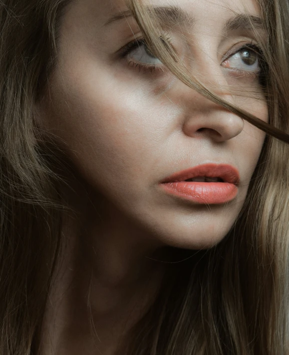 the woman is brushing her long brown hair