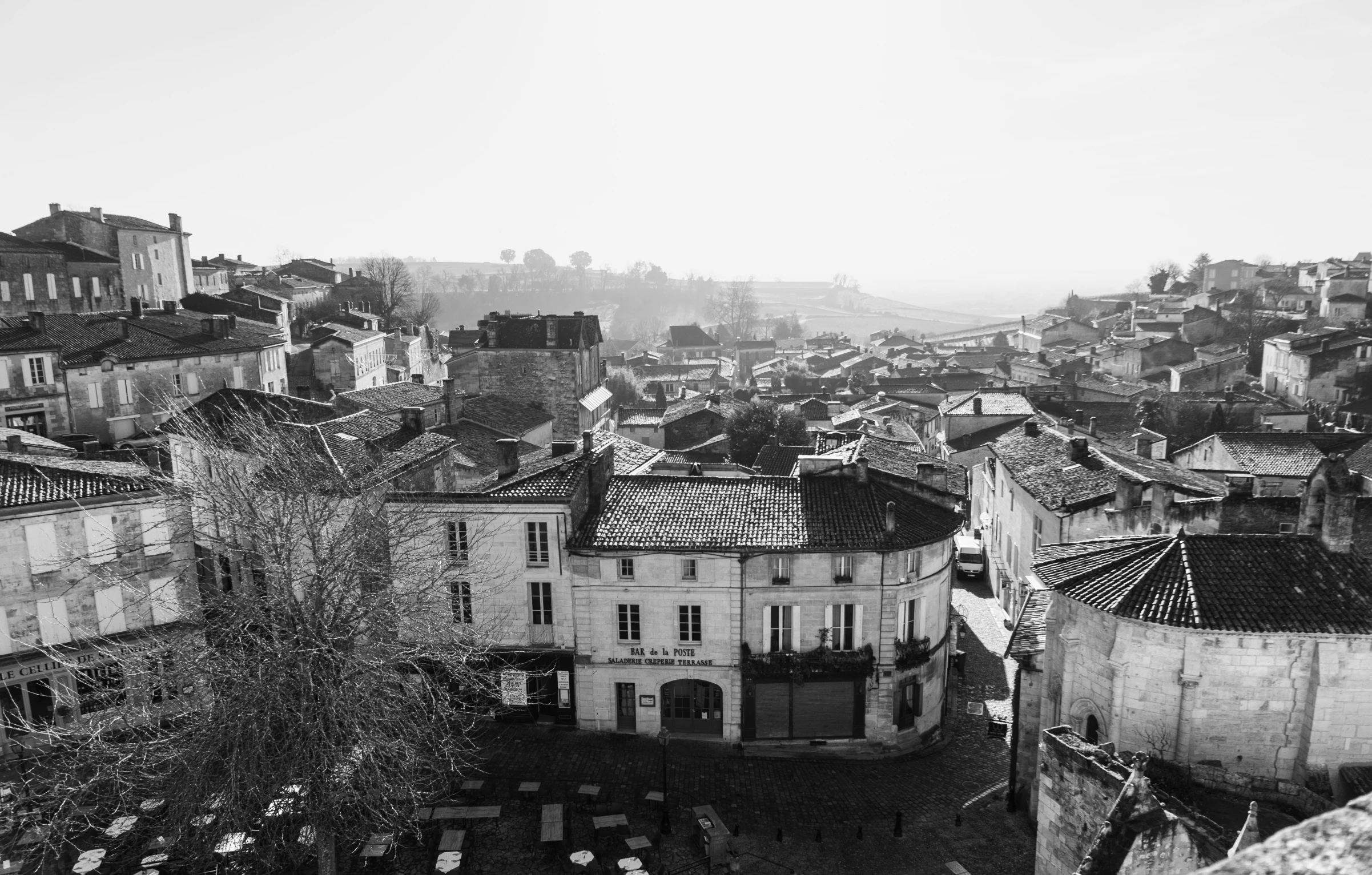 cityscape with old buildings on hillside in black and white