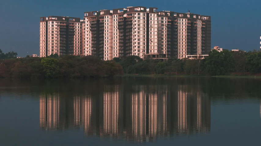 a large building is in front of a lake