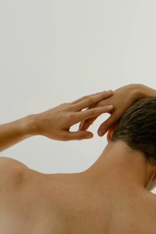 a man holding his head in front of the camera