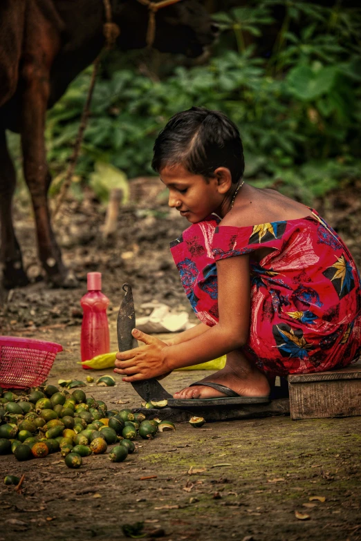 a woman kneeling down to pick up soing