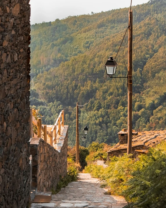 a pathway near the hill leading towards a light pole