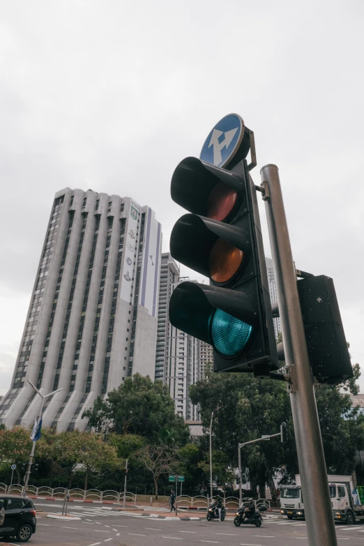 a stop light has three green lights, and is also red