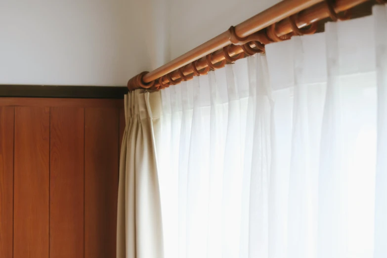 a window with a curtain hanging near a door