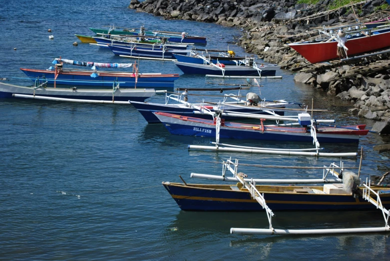 several boats sitting out on the ocean shore