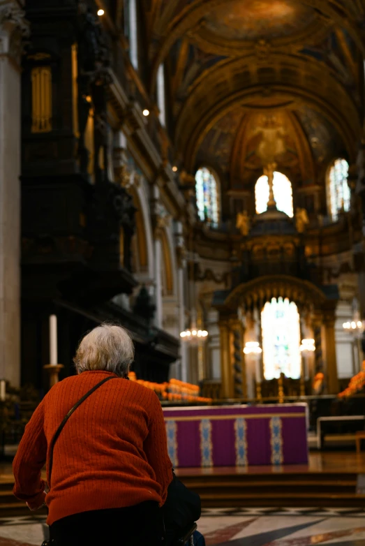 a person sits on the floor looking down