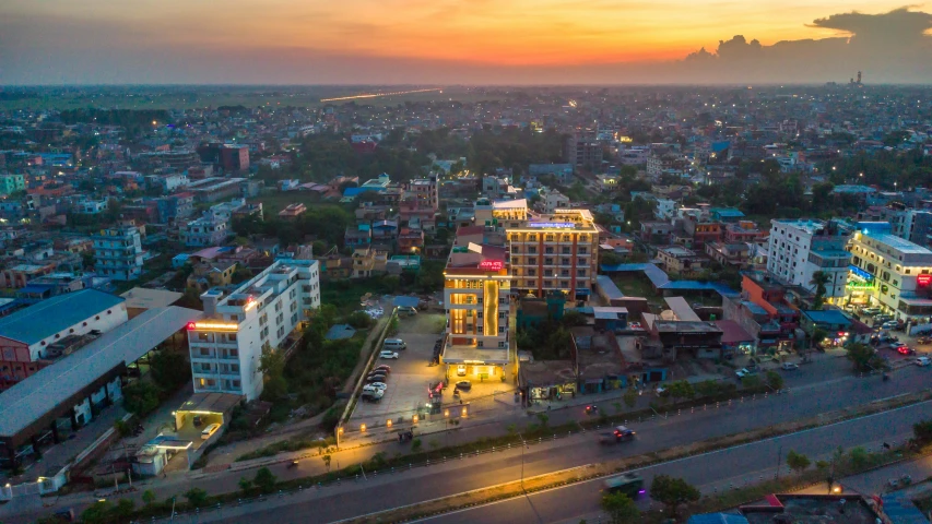 the view from the height of a tall building looking towards a city at sunset