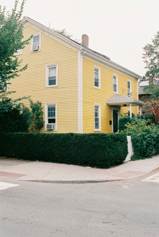 there is a yellow house with two story