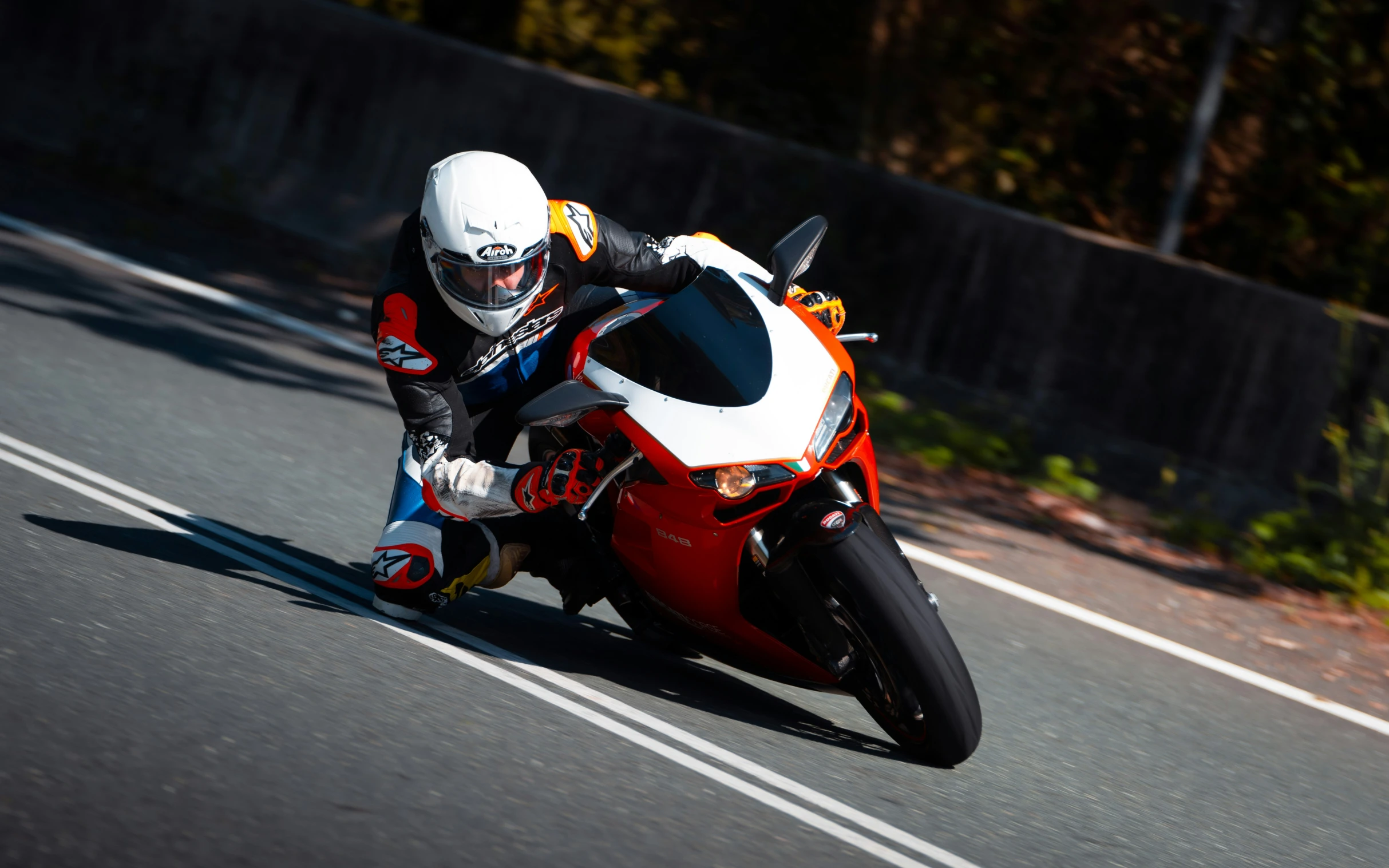 the motorcycle racer leans in to turn into a corner