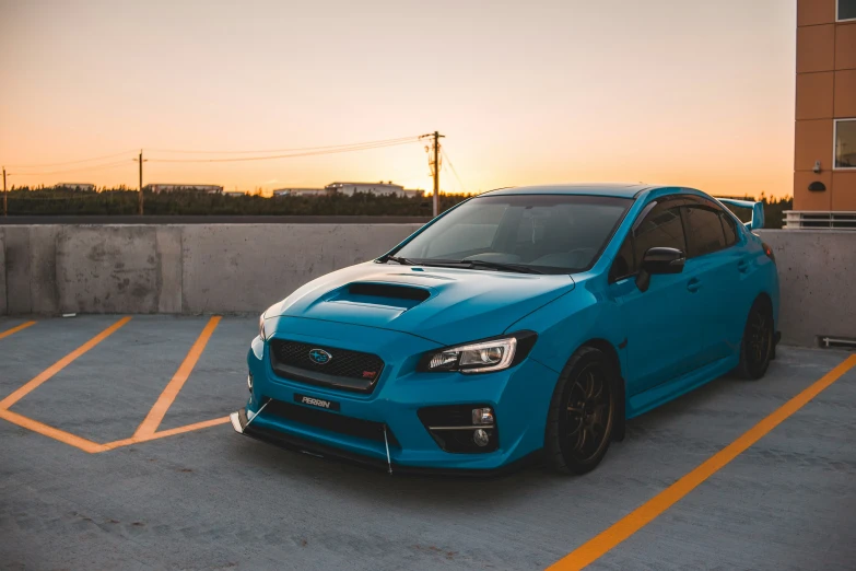 a blue subarunt parked in an empty parking lot