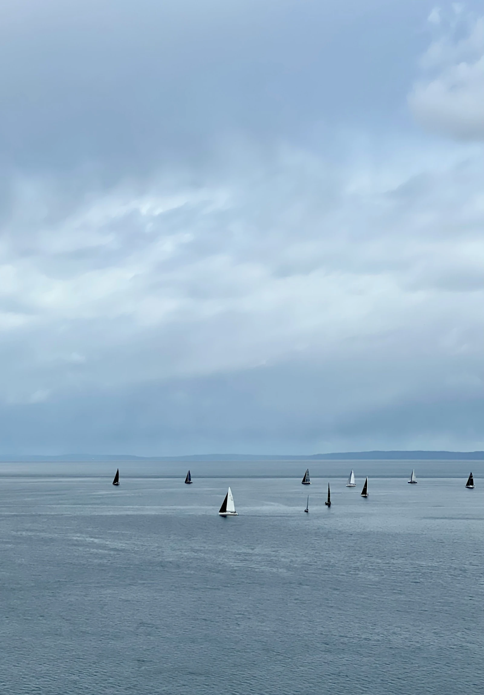 several boats sailing on a body of water