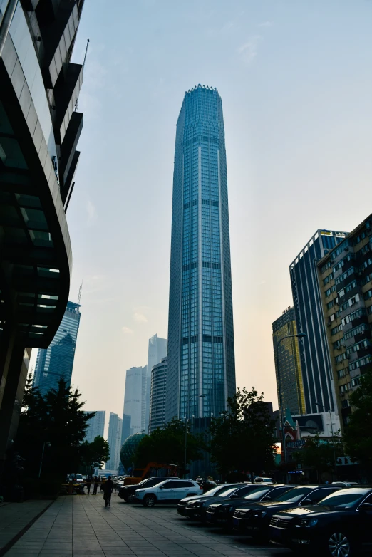 several tall buildings in the background with people walking