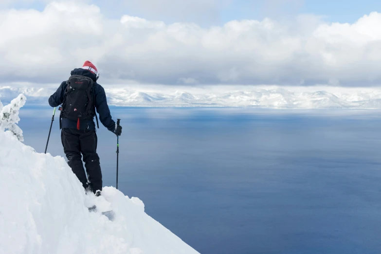 a person in skis looking down at the snow