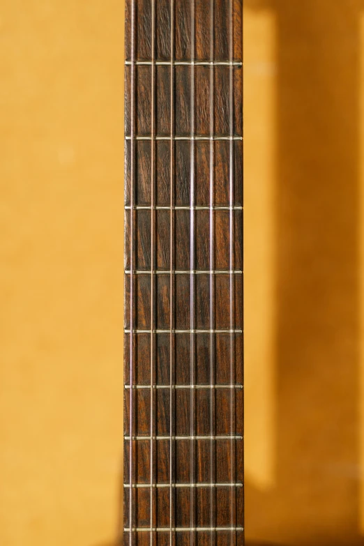 the guitar neck of a dark wood bass