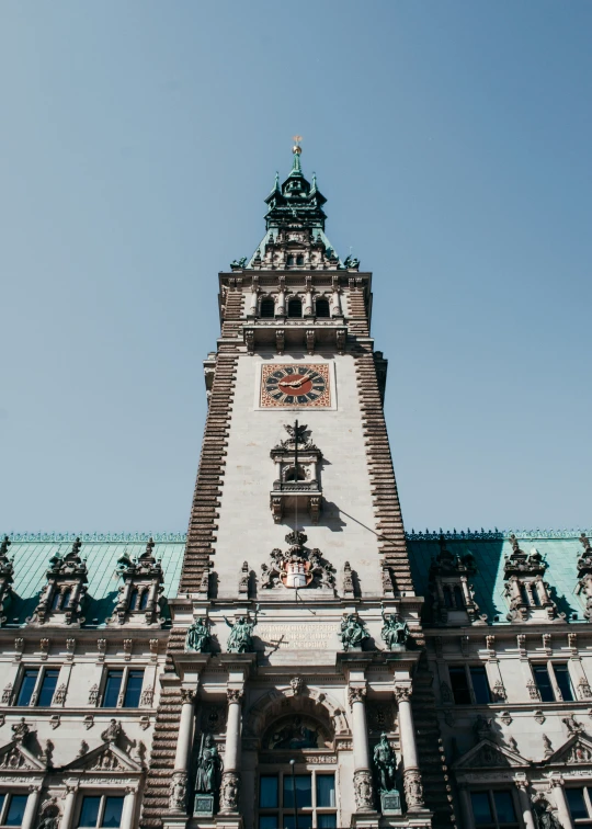 a tall building has many statues around it