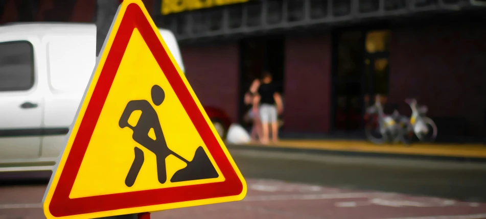 yellow and red caution sign about to make use of a crosswalk