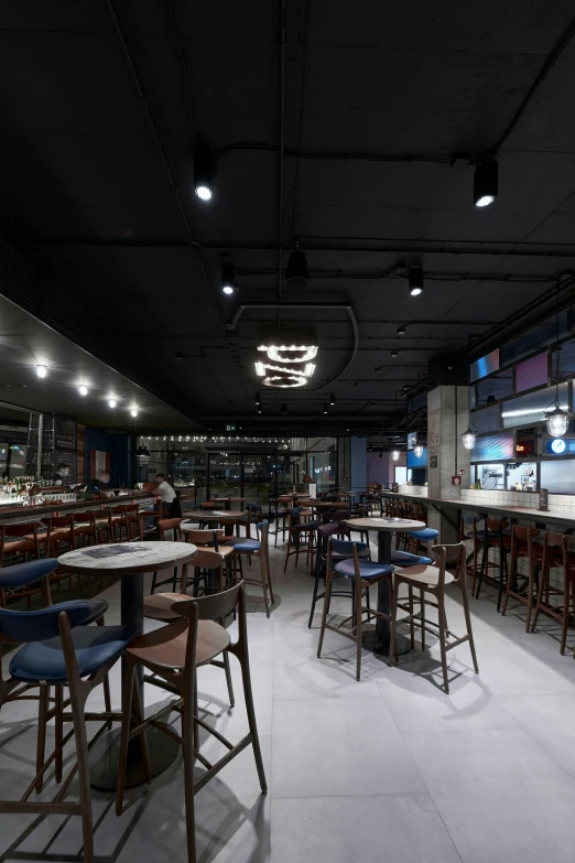 a restaurant is lit by spotlights and dim lighting