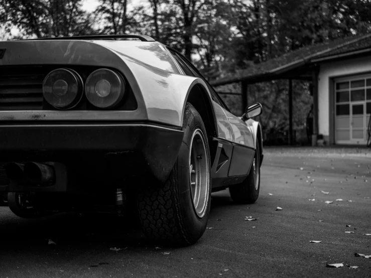 a black and white po of a car parked on the side of a road