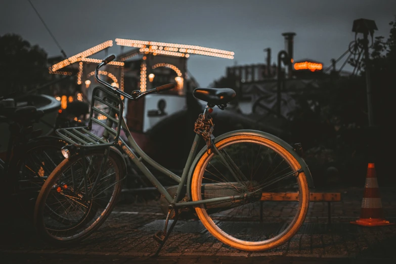 an old bike is sitting on the pavement