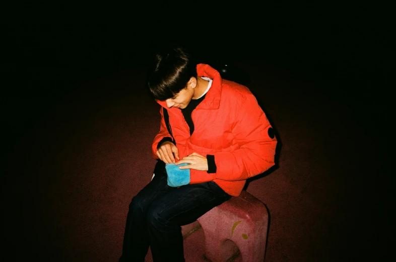 a person sitting on top of a bench with a phone