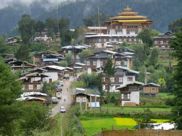 an area with several buildings and mountains in the background