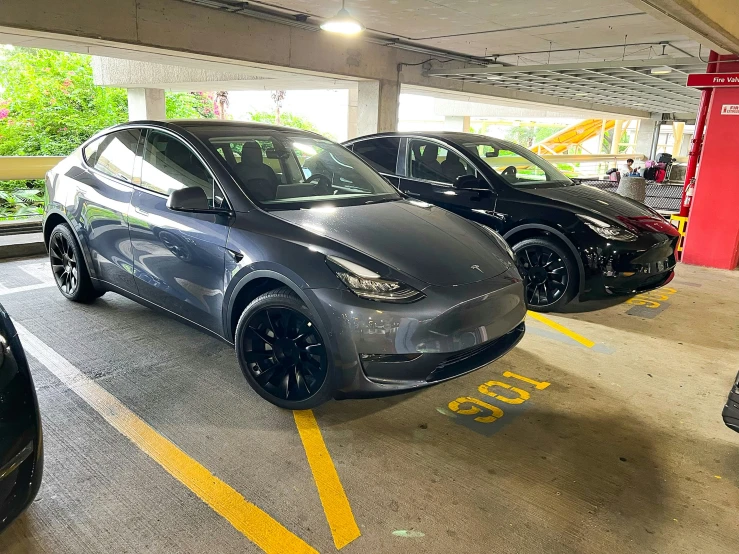 two cars parked next to each other in a parking lot