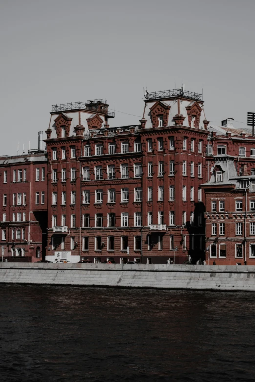an old building with red brick, near water