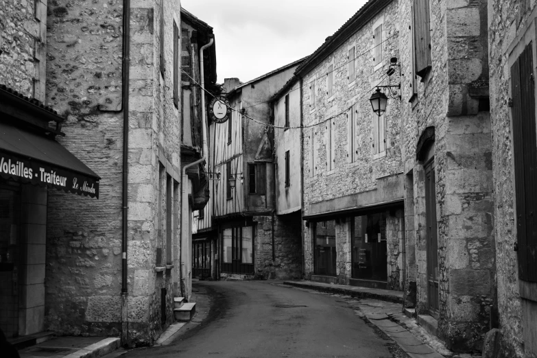 an old alleyway shows the buildings at the end of one