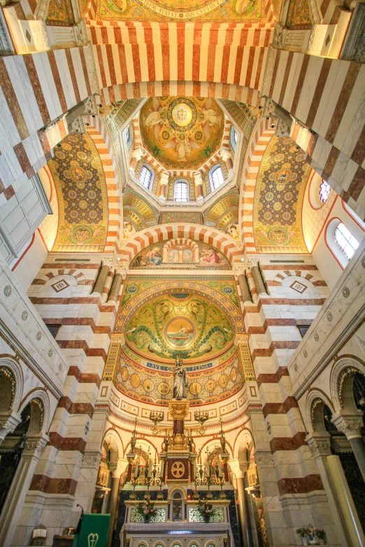 the interior of a church with multiple colored tiles on the ceiling