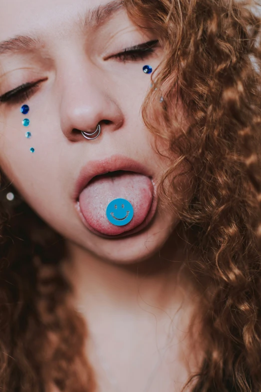 a girl with an expression that has a blue bubble coming out her mouth